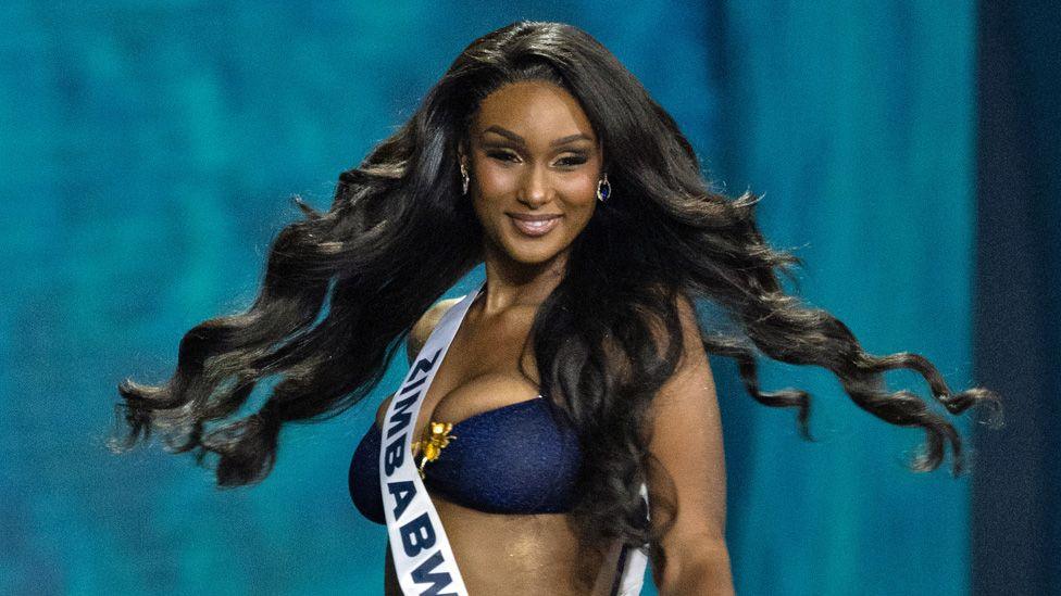 Miss Universe Zimbabwe, Lyshanda Moyas, swishes her long hair during a swimwear round at a beauty pageant on 21 November 2025 in Bangkok, Thailand. 
