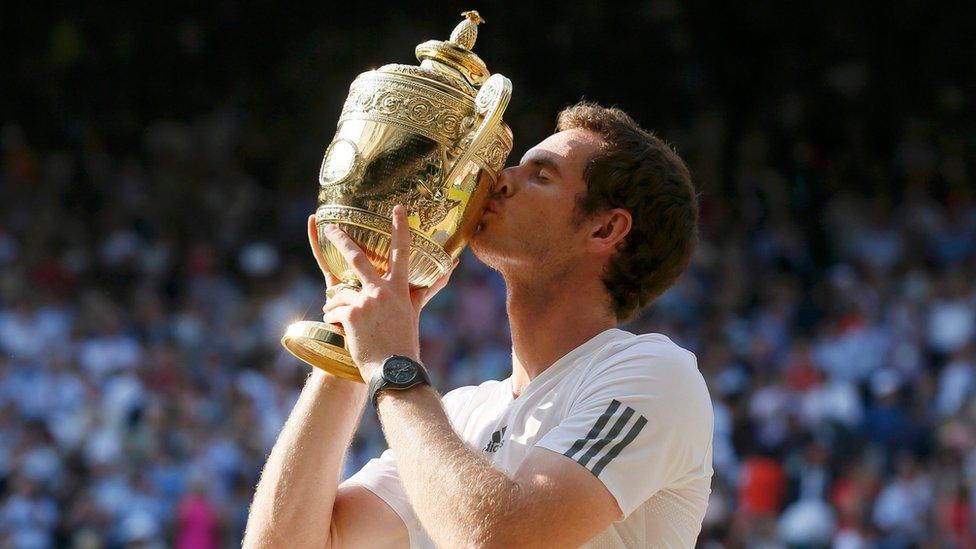 Andy Murray of Britain kisses the winners trophy after defeating Novak Djokovic of Serbia in their men's singles final tennis match at the Wimbledon Tennis Championships, in London July 7, 2013.