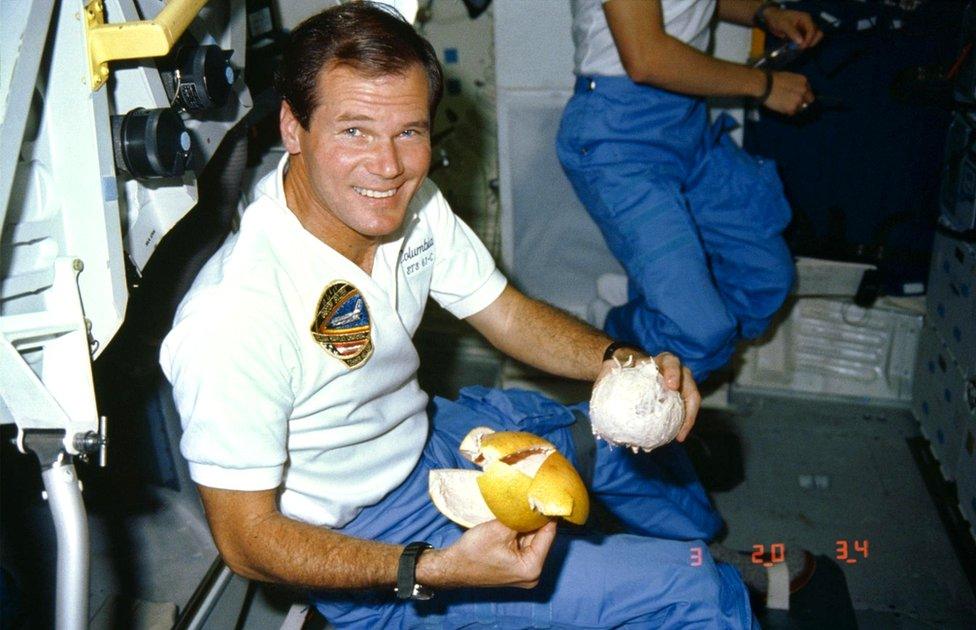 Nelson enjoys a grapefruit aboard the space shuttle Columbia in 1986