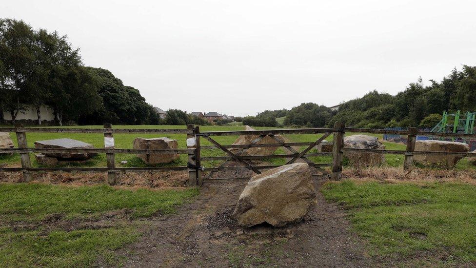 Playing fields at Grange Moor with boulders that travellers attempted to remove to gain access to the site