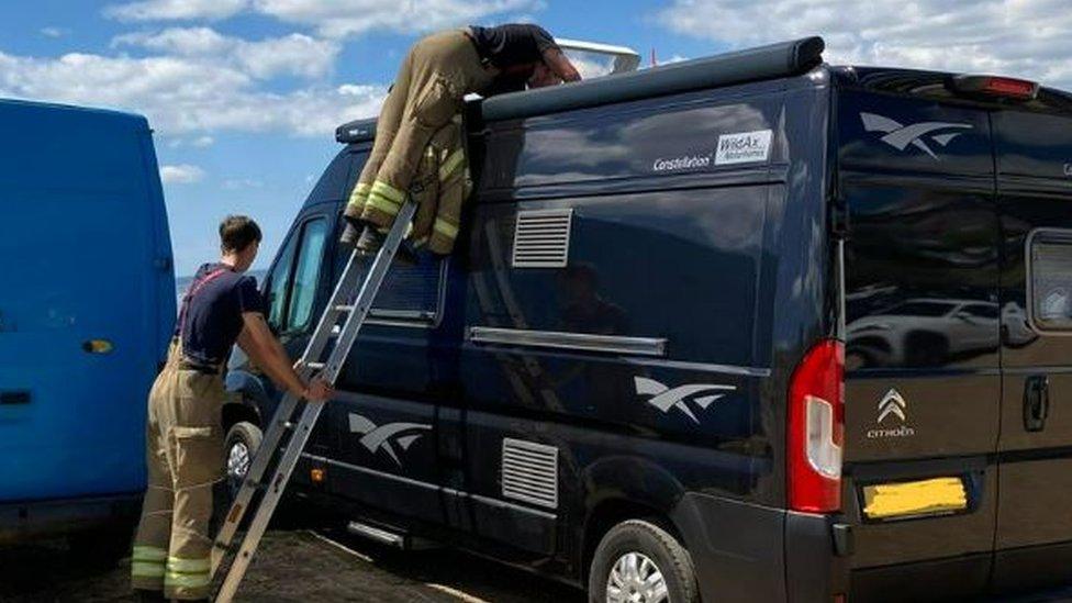 Two fire fighters and the camper van