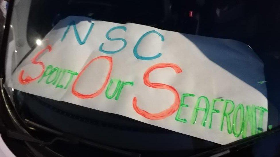 Save our Seafront banner on a car dashboard