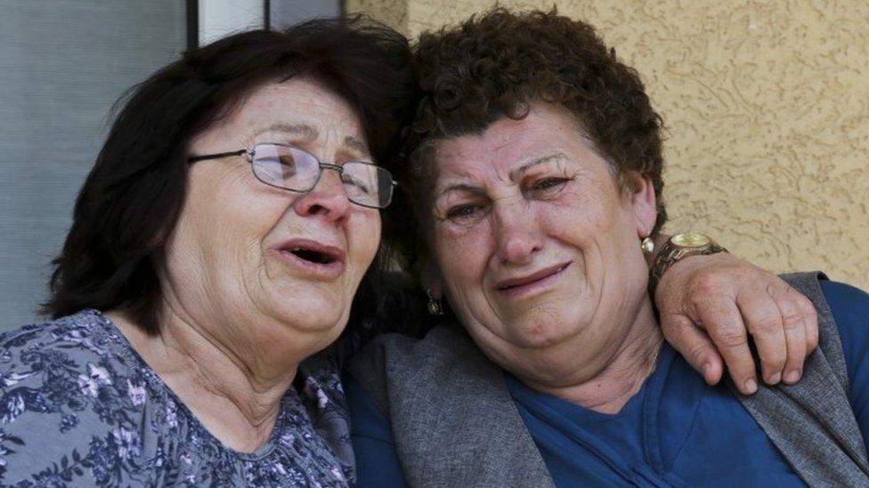 The aunts of Armela Segashi, one of the victims fatally shot at the Olympia shopping mall in Munich, react, in the town of Podujevo, Kosovo on Saturday, July 23, 2016