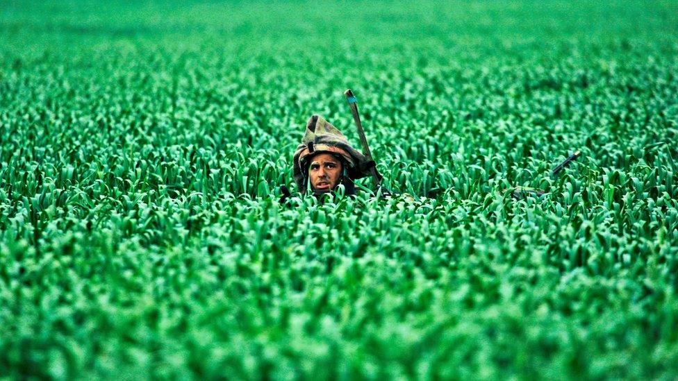 An Israeli soldier walking in fields near the Gaza Strip in 2008