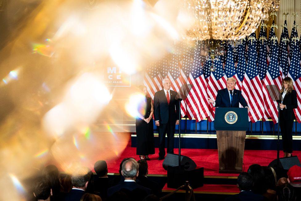 President Donald J. Trump speaks with First Lady Melania Trump, Vice President Mike Pence and wife Karen Pence during an election night event in the East Room at the White House early in the morning on Wednesday, Nov 04, 2020 in Washington, DC. 