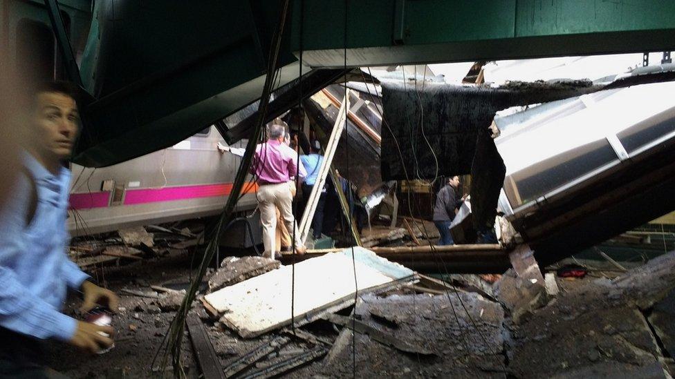 People examine the crashed train