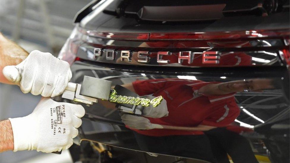 Mechanic polishing Porsche car