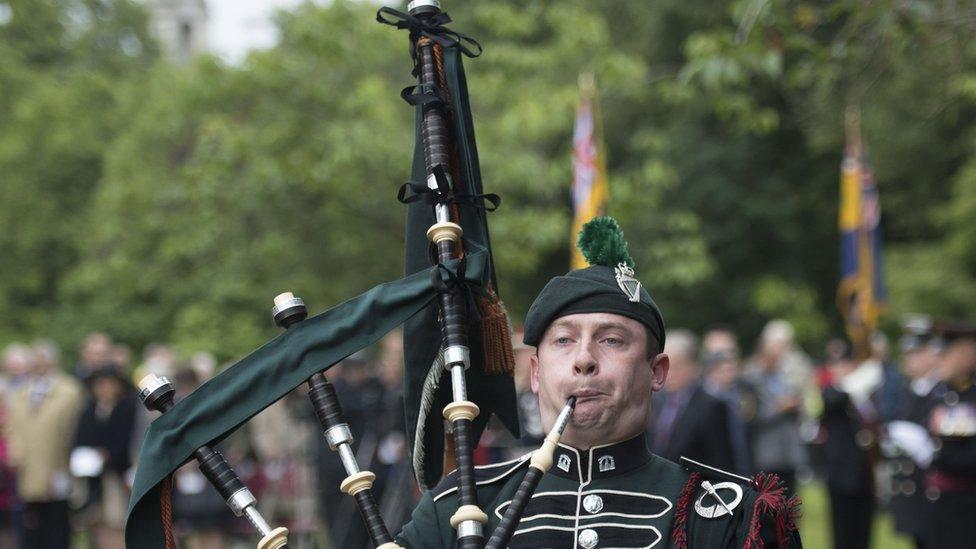 A piper marks the commemorations in Cardiff