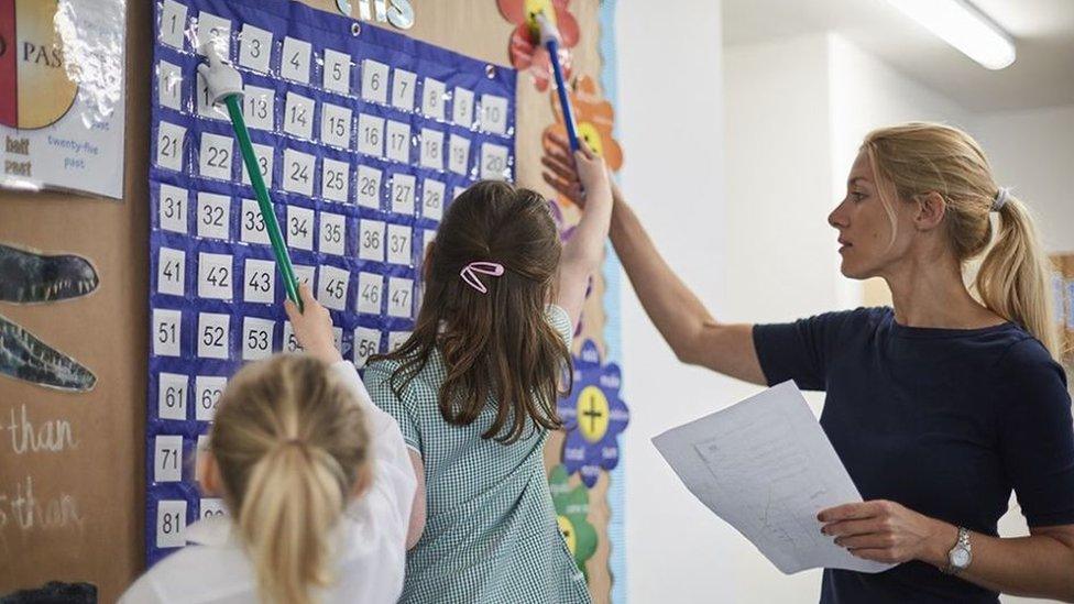 Child in a class with teacher