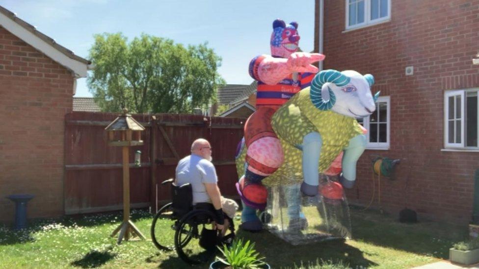 Jason Wilsher-Mills next to an inflatable sculpture