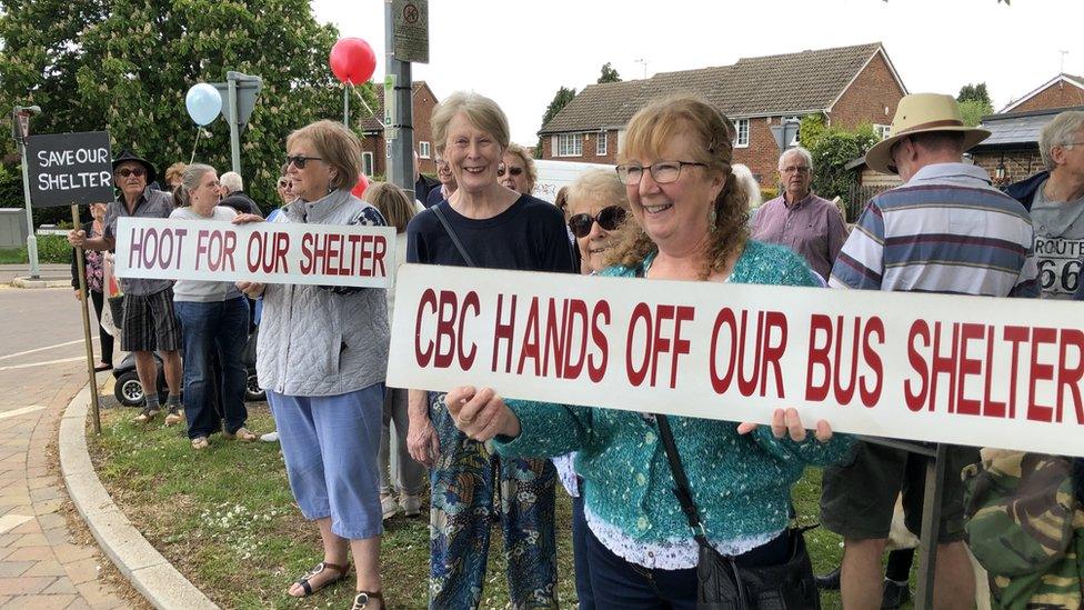 People holding up signs