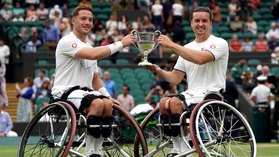 Alfie Hewett and Gordon Reid celebrate with the trophy following their victory over Takuya Miki and Tokito Oda Men's Wheelchair Doubles Final