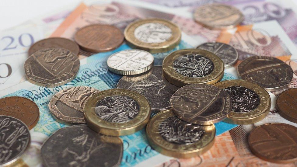 Notes and coins spread on a table