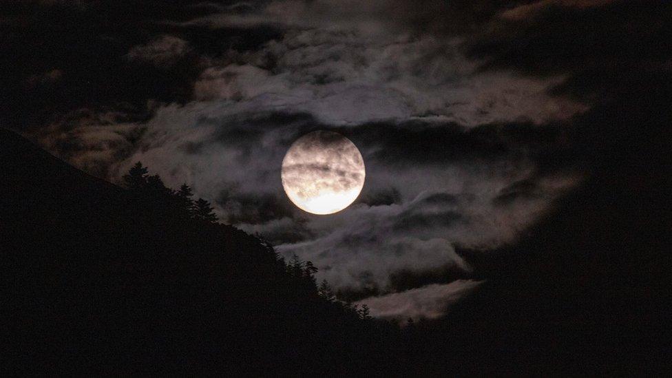 Super blue moon in the sky with clouds