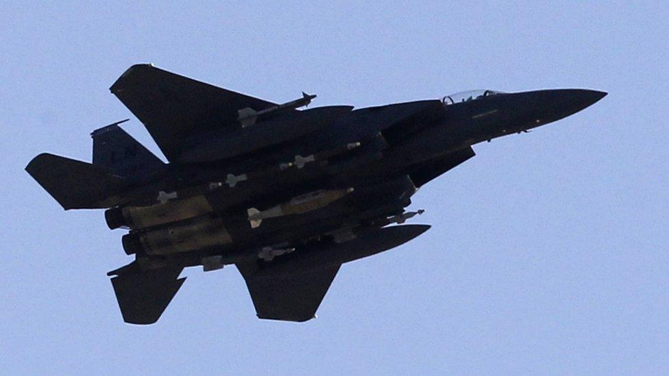 A US Air Force F-15 aircraft flies over Afghan and French soldiers participating in operation Spear Tackle 2 in Surobi district on September 26, 2010.