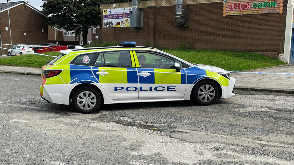 A police officer guards the taped off crime scene