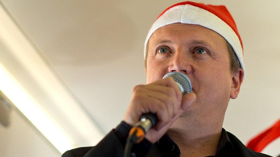 Aled-Jones-shown-dressed-in-santa-hat.