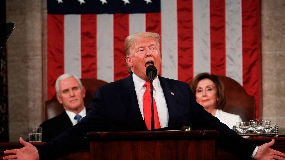 president trump in front of american flag