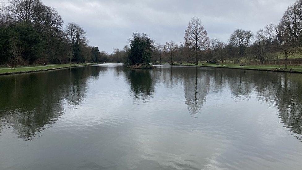 The lake at the pleasure grounds, with the surrounding trees reflected in it