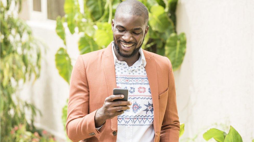 Smiling man checking his phone