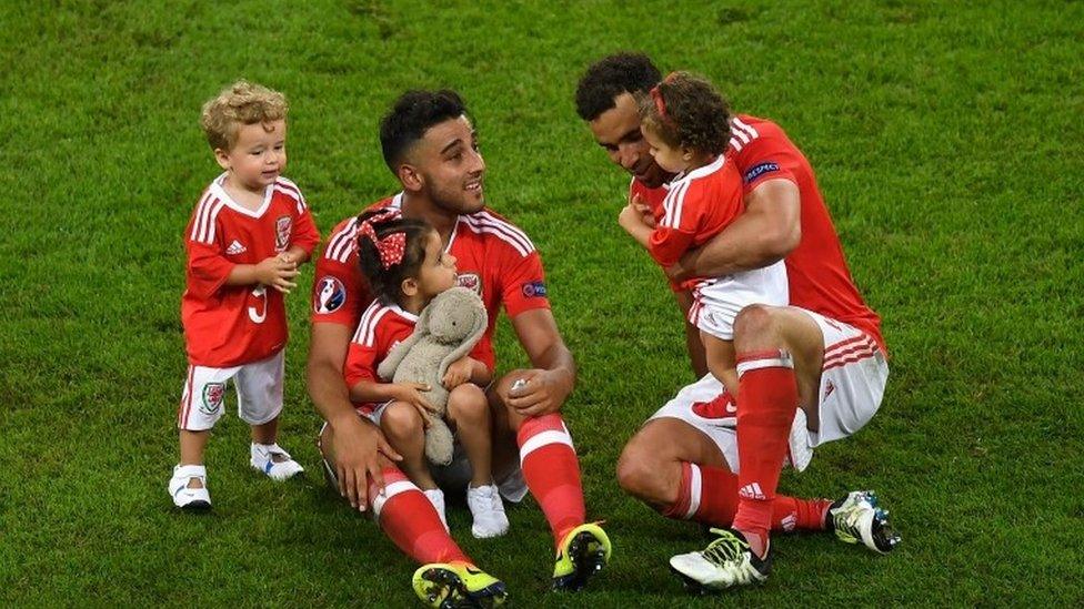 Neil Taylor (L) and Hal Robson-Kanu (R) of Wales celebrate their team"s 3-1 win with their children