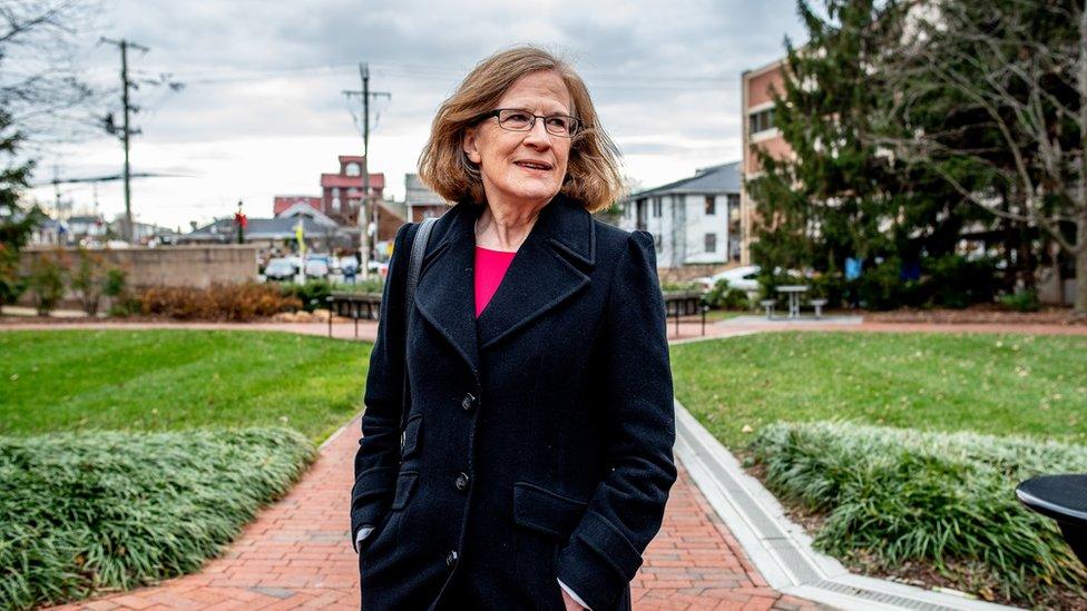 Loudoun County's Kristen Umstattd - standing in front of a set of buildings