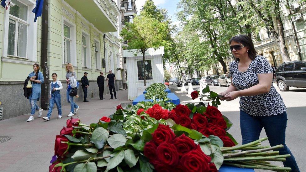 Woman laying flowers