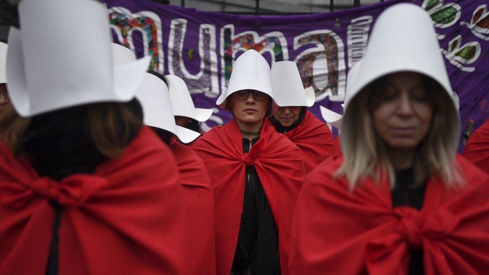 protesters in Argentina dressed as handmaids