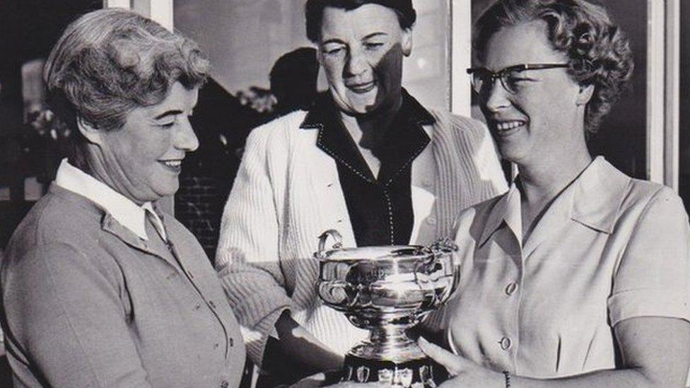 Woman receiving trophy