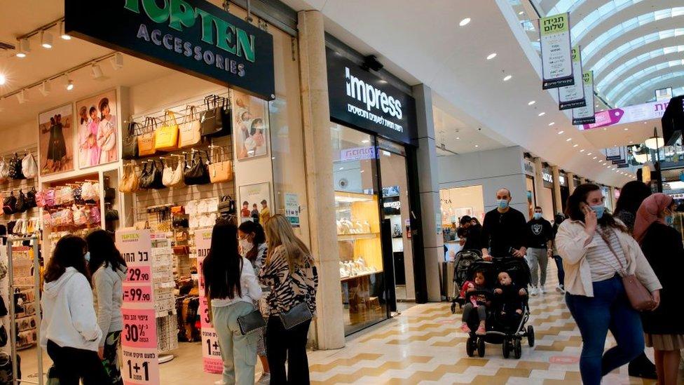 People visit a shopping mall in Modiin, Israel, since covid restrictions were lifted