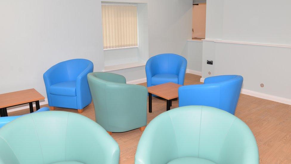 One of the rooms at the hub. Green and blue chairs are pictured