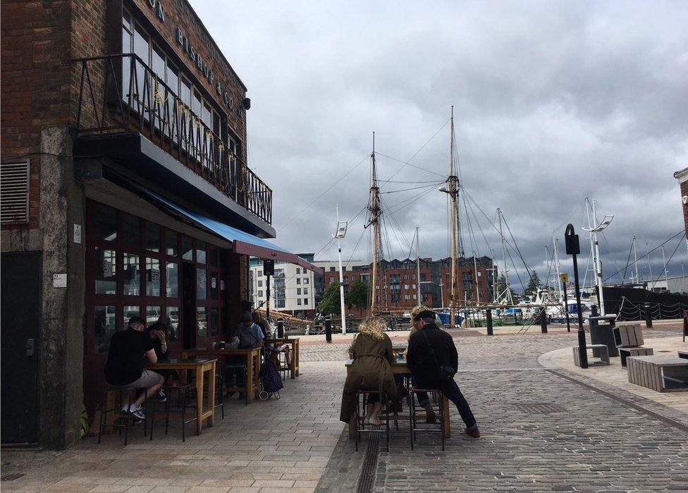 People drink outside of a pub