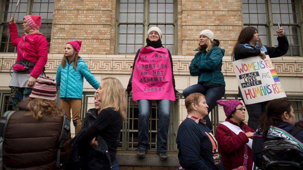 A women wears a cape that reads 'I had an abortion, Im not ashamed or Sorry!' as demonstrators march down Independence Avenue during the Women's March on Washington in Washington, DC,