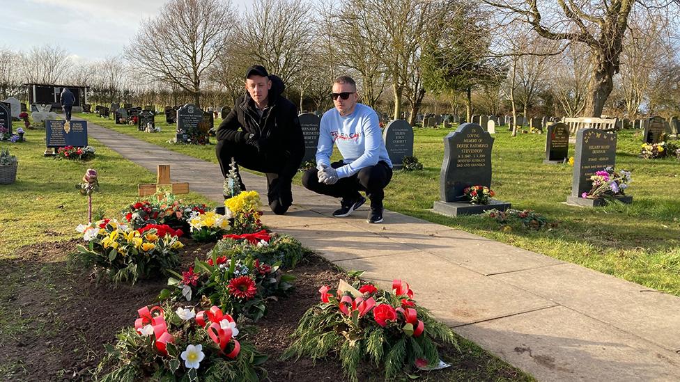 Brothers by their father's grave