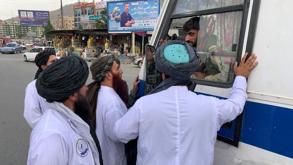 Vice and Virtue officials question a bus driver in Kabul