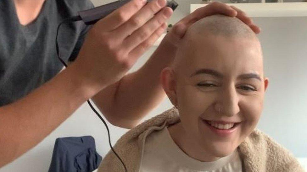 Ella Hines getting her head shaved by her partner