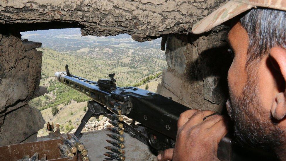 A Pakistani soldier keeps vigil from a post on top of a mountain in the former Taliban militants stronghold border area in Shawal valley on 20 May 2016