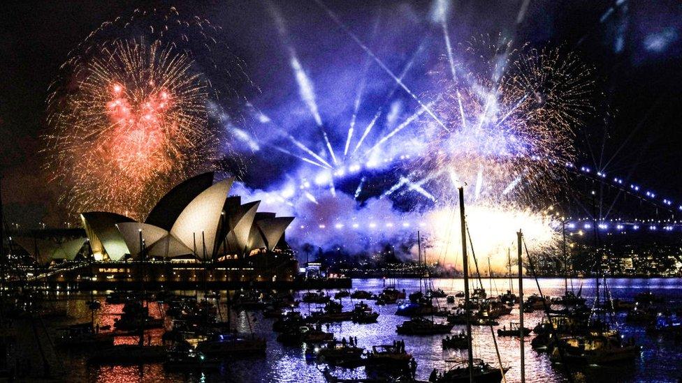 Fireworks - in orange, white and blue - seen over the Sydney Opera House and Harbour Bridge