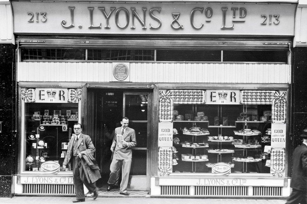 The exterior of a Lyons tea shop along Piccadilly, London, 2nd July 1953. The shop window has been decorated to commemorate the coronation of Queen Elizabeth II