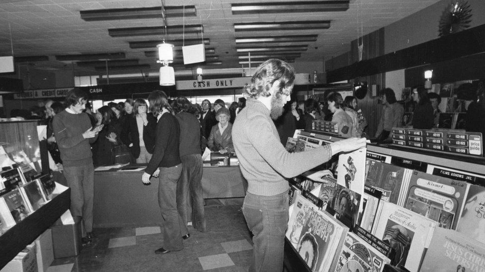 Shoppers browsing and buying in HMV in 1976