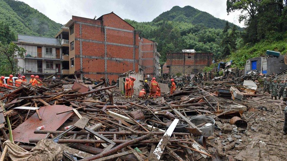 Rescuers search through rubble