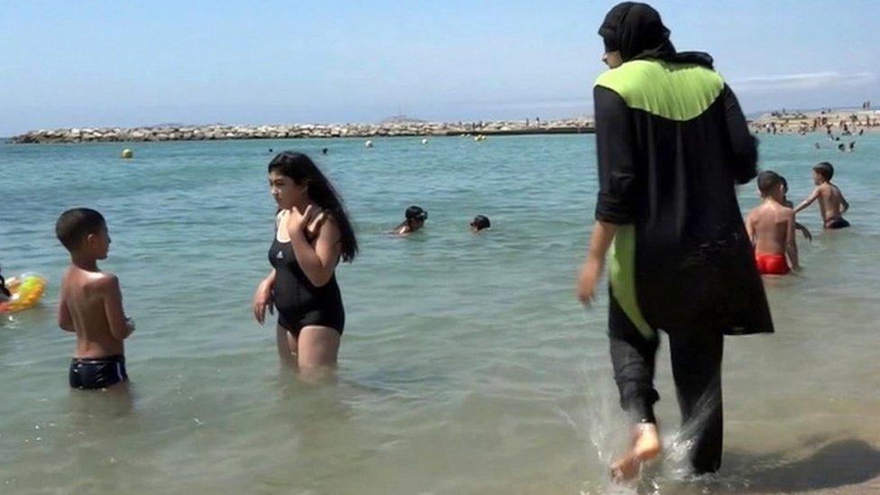 A woman in a Burkini at the beach.