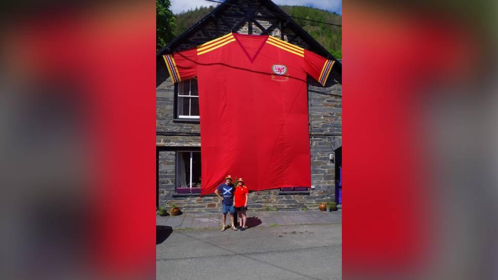 the giant shirt hanging on the front of the house