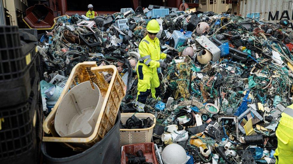 The Ocean Cleanup crew sorts through plastic on a ship deck after an extraction