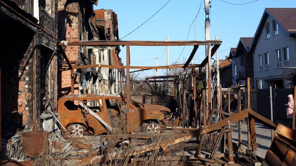 Scenes from Ukraine including burnt-out buildings and cars