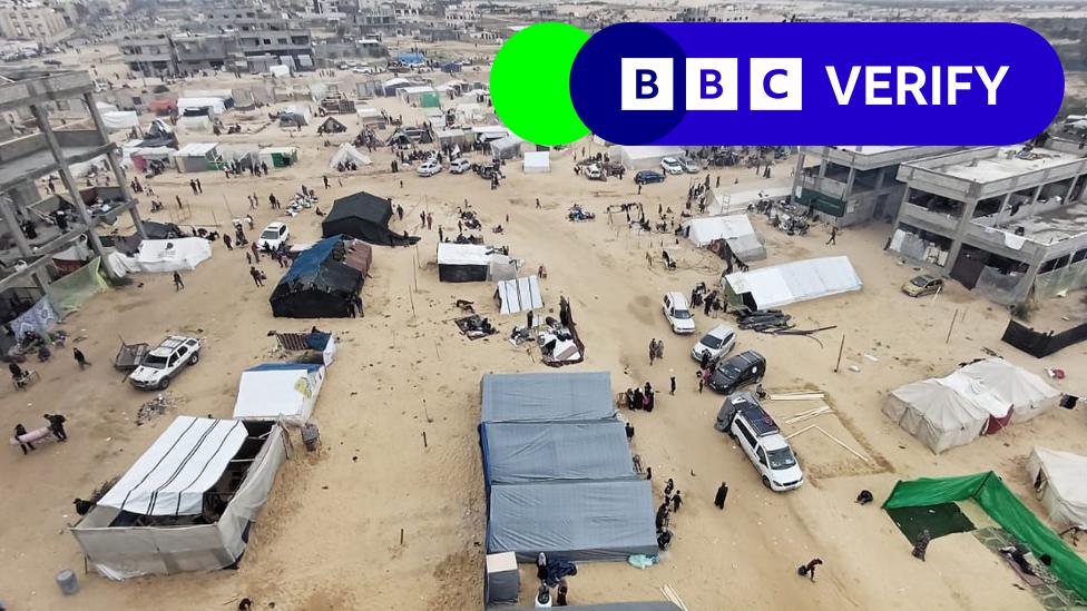 A photo overlooking Al-Mawasi. People and tents can be seen in the foreground