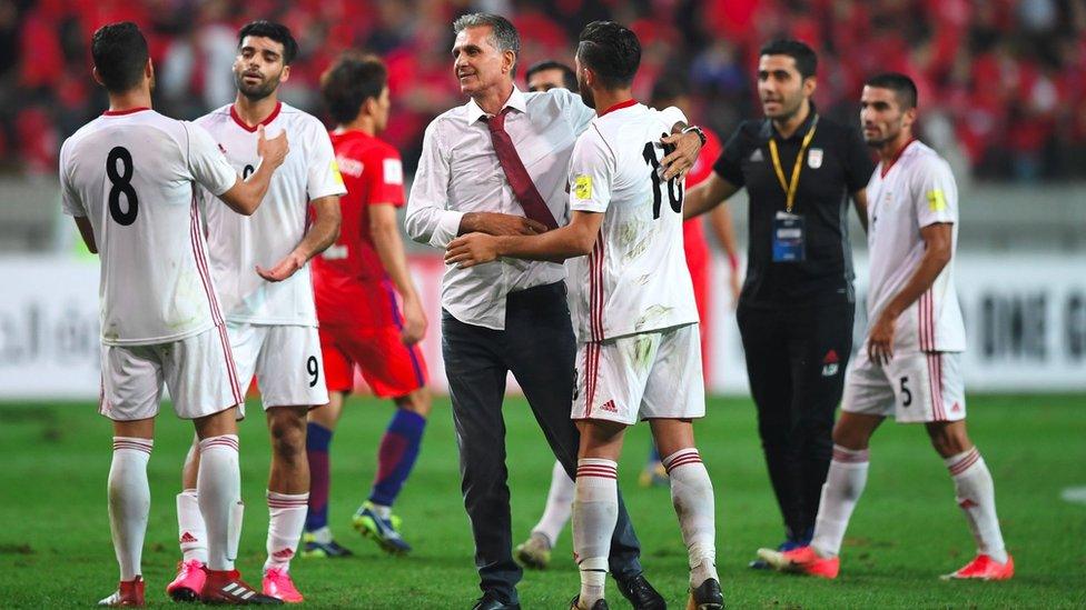 Iran's head coach Carlos Queiroz (C) reacts with his players after a match with South Korea in Seoul on 31 August 2017