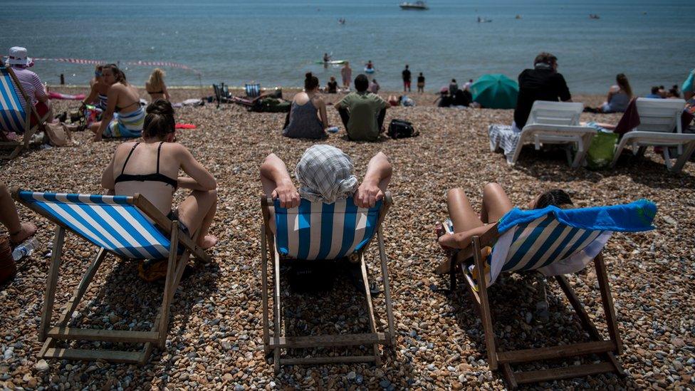 People sunbathing in Brighton