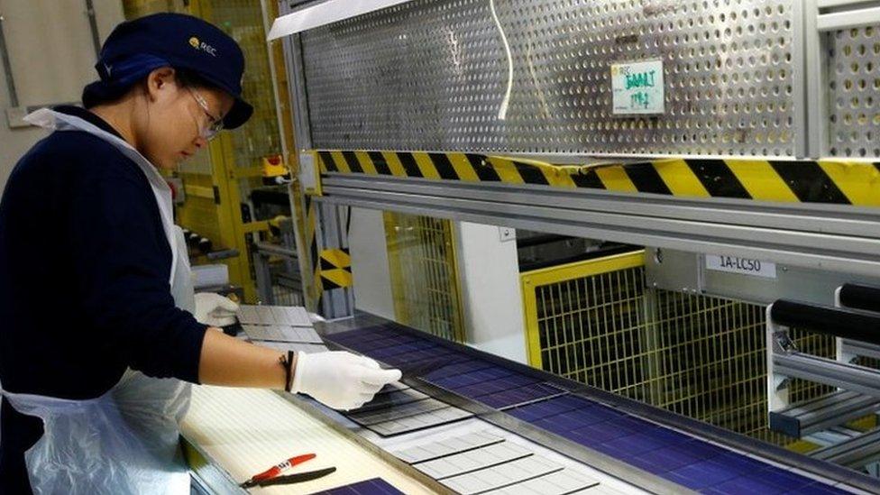 Woman in a solar panel factory