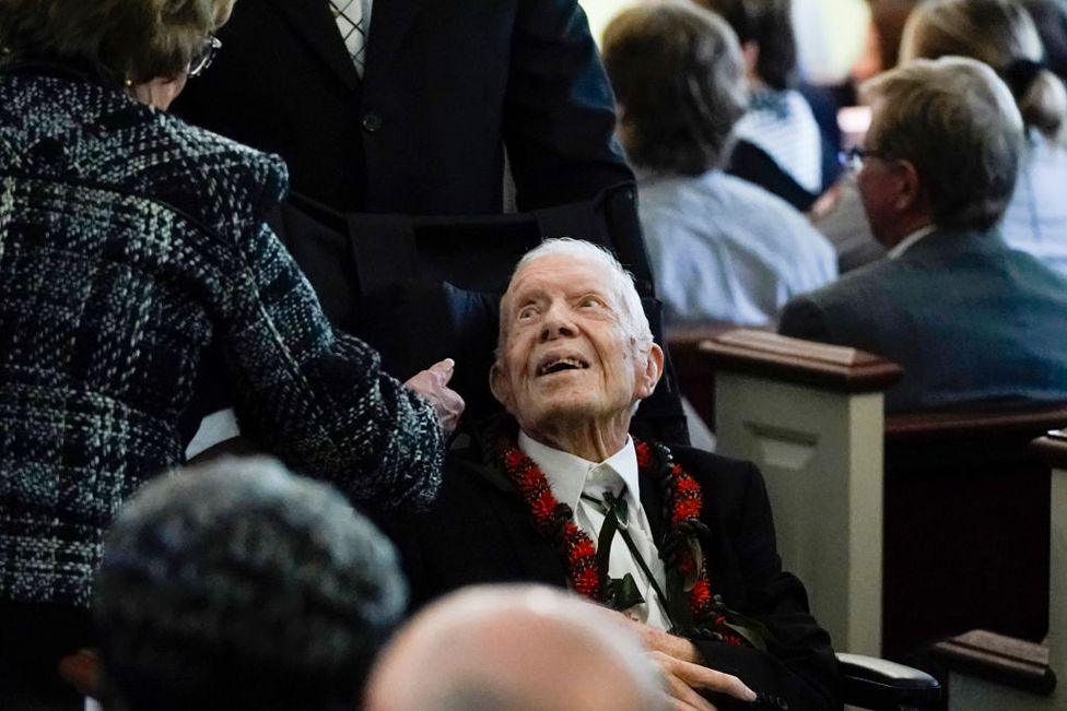 Former US President Jimmy Carter departs following a funeral service for former US First Lady Rosalynn Carter, at Maranatha Baptist Church in Plains, Georgia, on November 29, 2023.